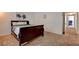 Bedroom featuring dark wood bed frame, soft neutral carpet, and hallway access to bathroom and other bedrooms at 2696 Matogroso Ln, Las Vegas, NV 89121