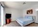 Cozy bedroom with plush carpet, light blue paisley bedding and sliding glass door to balcony at 2696 Matogroso Ln, Las Vegas, NV 89121
