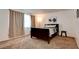 Inviting bedroom featuring a dark wood bed frame, plush carpeting, and soft natural light from the window at 2696 Matogroso Ln, Las Vegas, NV 89121