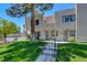 Beautifully landscaped front yard with green grass and mature trees at 2696 Matogroso Ln, Las Vegas, NV 89121