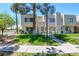 Two story home with a well-manicured lawn and mature trees providing shade at 2696 Matogroso Ln, Las Vegas, NV 89121