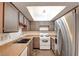 Cozy kitchen featuring stainless steel refrigerator, wood cabinets, and laminate countertops at 2696 Matogroso Ln, Las Vegas, NV 89121
