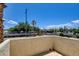 Balcony features a textured wall, bright blue skies, palm trees, and views of the community at 2696 Matogroso Ln, Las Vegas, NV 89121