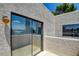 Patio features sliding glass doors, and textured stucco walls with blue sky visible in reflection at 2696 Matogroso Ln, Las Vegas, NV 89121