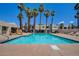 Enjoy the community pool surrounded by palm trees, lounge chairs, and well-maintained landscaping at 2696 Matogroso Ln, Las Vegas, NV 89121