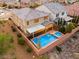 Lush backyard featuring a swimming pool, spa, covered patio, and immaculate landscaping at 2832 Aragon Terrace Way, Henderson, NV 89044