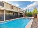 Inviting backyard with a shimmering pool, shaded patio, and lush landscape at 2832 Aragon Terrace Way, Henderson, NV 89044