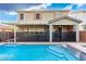Beautiful backyard featuring a refreshing pool, covered patio, and well-maintained landscape at 2832 Aragon Terrace Way, Henderson, NV 89044