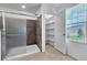 Elegant bathroom featuring a spacious walk-in shower, storage shelves and natural light at 2832 Aragon Terrace Way, Henderson, NV 89044