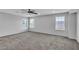 Spacious bedroom features neutral paint and carpet, a ceiling fan, and several windows at 2832 Aragon Terrace Way, Henderson, NV 89044