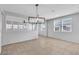 Spacious dining room with tile flooring, stylish chandelier and views to the exterior, blending natural light with design at 2832 Aragon Terrace Way, Henderson, NV 89044