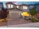 Inviting two-story home with a brick driveway and a well-manicured lawn at 2832 Aragon Terrace Way, Henderson, NV 89044