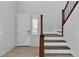 Bright foyer with a staircase featuring white risers and wood treads, and a view to the exterior through a window at 2832 Aragon Terrace Way, Henderson, NV 89044