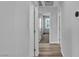 Hallway showcasing wood-look floors and neutral paint, leading to carpeted bedrooms at 2832 Aragon Terrace Way, Henderson, NV 89044