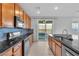 Updated kitchen with black granite countertops and stainless appliances at 2832 Aragon Terrace Way, Henderson, NV 89044