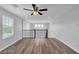 Bright loft area featuring wood-look floors, a ceiling fan, and a railing overlooking the floor below at 2832 Aragon Terrace Way, Henderson, NV 89044