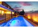 Backyard featuring a private pool and spa, with wrought iron fencing and serene landscape lighting at 2832 Aragon Terrace Way, Henderson, NV 89044