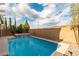 Backyard oasis with sparkling pool, integrated spa, and lush greenery and mountain views at 2832 Aragon Terrace Way, Henderson, NV 89044