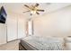 Bedroom featuring wood-look flooring, a ceiling fan, closet, and mounted TV at 2874 Avanti Ln, Henderson, NV 89074
