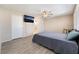 Bedroom features light walls, plank floors, ceiling fan, and access to the bathroom at 2874 Avanti Ln, Henderson, NV 89074