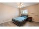 Simple bedroom featuring wood-look flooring, ceiling fan, and a window providing natural light at 2874 Avanti Ln, Henderson, NV 89074