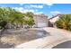 Charming home featuring a well-maintained front yard with desert landscaping and a spacious driveway at 2874 Avanti Ln, Henderson, NV 89074
