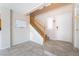 Bright foyer with tiled floors, white walls, a staircase, and a front door at 2874 Avanti Ln, Henderson, NV 89074