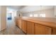 Upstairs hallway features built-in wood cabinets and new, light-colored vinyl flooring at 2874 Avanti Ln, Henderson, NV 89074