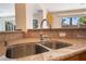 Close-up of the kitchen sink with stainless fixtures and a granite-style countertop at 2874 Avanti Ln, Henderson, NV 89074