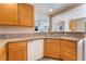 This kitchen has stainless steel sinks and a white dishwasher that accent the wood cabinetry at 2874 Avanti Ln, Henderson, NV 89074