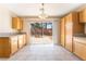 Kitchen boasts sliding door access to the back patio, light-colored cabinets, and tile flooring at 2874 Avanti Ln, Henderson, NV 89074