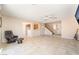 Inviting living room with tile flooring, ceiling fan, and staircase access at 2874 Avanti Ln, Henderson, NV 89074