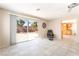 Open concept living room with tiled flooring, a ceiling fan, and a sliding glass door at 2874 Avanti Ln, Henderson, NV 89074