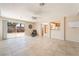 Open concept living room with tiled flooring, a view of the kitchen, and a sliding glass door at 2874 Avanti Ln, Henderson, NV 89074