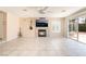Bright living room with fireplace, tile floors, and sliding glass door to the backyard at 2874 Avanti Ln, Henderson, NV 89074