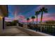A charming balcony offers breathtaking sunset views and palm trees in a beautiful setting at 3042 Hammerwood Dr, Las Vegas, NV 89135