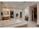 Spacious bathroom with a large soaking tub, walk-in closet, and vanity area at 3042 Hammerwood Dr, Las Vegas, NV 89135