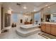 Luxurious bathroom with a soaking tub, glass block accents, and dual vanities at 3042 Hammerwood Dr, Las Vegas, NV 89135