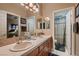 Bright bathroom featuring double sinks, a large mirror, and tile countertops at 3042 Hammerwood Dr, Las Vegas, NV 89135