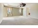 Large bedroom with tray ceilings, neutral paint, carpet, and large windows at 3042 Hammerwood Dr, Las Vegas, NV 89135