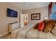 Inviting bedroom with a TV, neutral walls, plush bedding, and access to an attached bathroom at 3042 Hammerwood Dr, Las Vegas, NV 89135