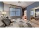 Bedroom with a large window and neutral tones, complemented by a stylish comforter set and built-in storage at 3042 Hammerwood Dr, Las Vegas, NV 89135