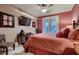Inviting bedroom with a ceiling fan, TV, and access to a balcony at 3042 Hammerwood Dr, Las Vegas, NV 89135