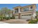 Elegant two-story home with a three-car garage, stone accents, and a well-maintained driveway at 3042 Hammerwood Dr, Las Vegas, NV 89135