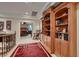 Hallway featuring custom bookshelves, comfortable seating, and tasteful decor, creating an inviting transition space at 3042 Hammerwood Dr, Las Vegas, NV 89135