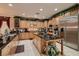 Gourmet kitchen features custom cabinetry, stainless steel appliances, and granite countertops at 3042 Hammerwood Dr, Las Vegas, NV 89135