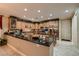 A spacious kitchen featuring dark countertops, custom cabinets, and stainless steel appliances at 3042 Hammerwood Dr, Las Vegas, NV 89135