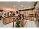 Spacious kitchen featuring granite countertops, custom cabinets, and stainless steel appliances at 3042 Hammerwood Dr, Las Vegas, NV 89135