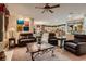 Comfortable living room with artwork, a ceiling fan, and a view into the kitchen area at 3042 Hammerwood Dr, Las Vegas, NV 89135