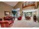 Spacious living room with high ceilings, balcony, dining area, and comfortable seating, great for entertaining at 3042 Hammerwood Dr, Las Vegas, NV 89135